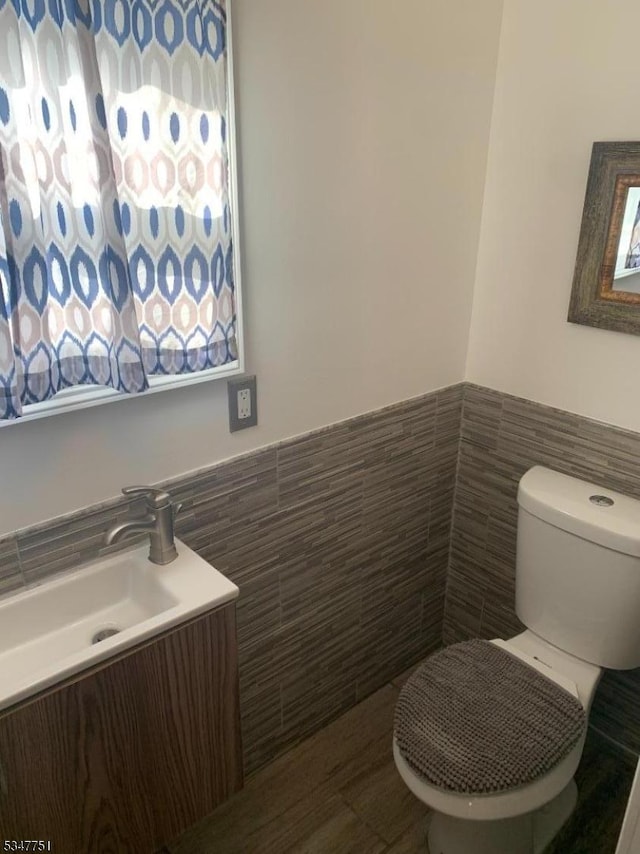 136 Willow St, Bloomfield Twp, NJ 07003 - bathroom with tile walls, a wainscoted wall, vanity, and toilet
