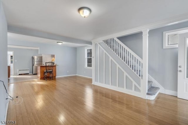 136 Willow St, Bloomfield Twp, NJ 07003 - unfurnished living room with radiator, stairway, wood finished floors, and baseboards