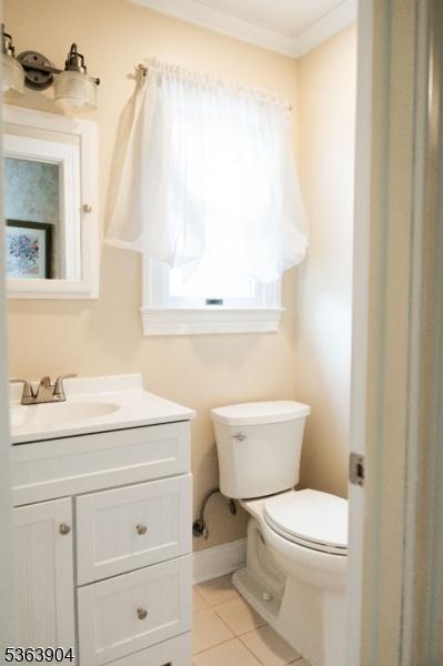 2 Monsey Rd, Raritan Twp, NJ 08822 - half bath featuring toilet, vanity, tile patterned floors, crown molding, and baseboards