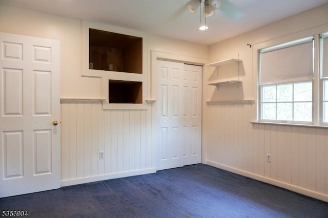 2 Monsey Rd, Raritan Twp, NJ 08822 - unfurnished bedroom with a wainscoted wall, a closet, ceiling fan, and dark wood finished floors
