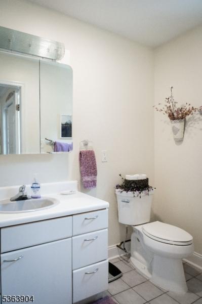 2 Monsey Rd, Raritan Twp, NJ 08822 - half bathroom with toilet, vanity, tile patterned flooring, and baseboards
