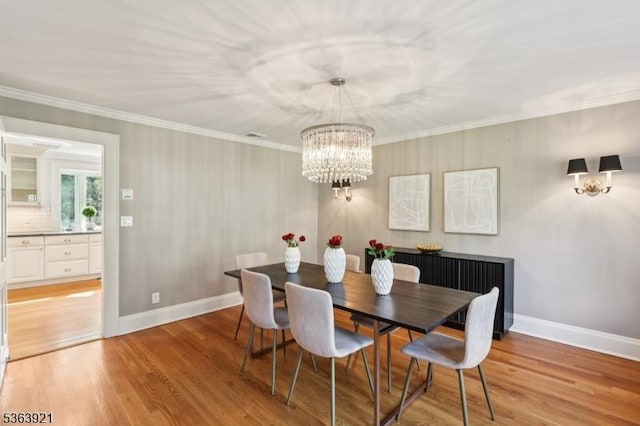 75 Farley Rd, Millburn Twp, NJ 07078 - dining area with light wood-style flooring, a chandelier, and ornamental molding