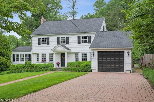 75 Farley Rd, Millburn Twp, NJ 07078 - colonial house with a garage, a chimney, decorative driveway, and a shingled roof