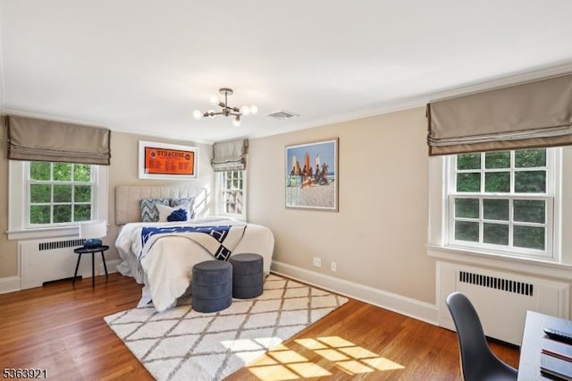 75 Farley Rd, Millburn Twp, NJ 07078 - bedroom with radiator heating unit, a chandelier, wood finished floors, and ornamental molding