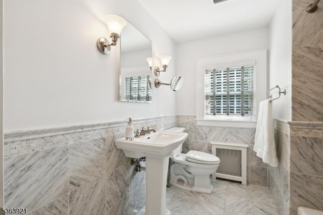 75 Farley Rd, Millburn Twp, NJ 07078 - bathroom with radiator heating unit, tile walls, and a wainscoted wall