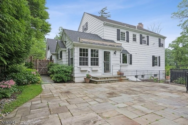 75 Farley Rd, Millburn Twp, NJ 07078 - back of house featuring a patio, a chimney, a gate, and a shingled roof
