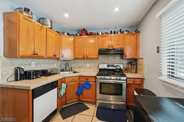 9 Lee Ct, Maplewood Twp, NJ 07040 - kitchen featuring white dishwasher, stainless steel gas range, under cabinet range hood, healthy amount of natural light, and recessed lighting