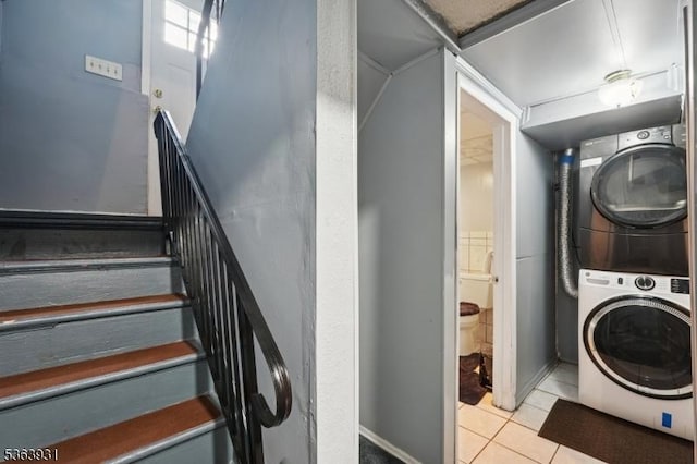 9 Lee Ct, Maplewood Twp, NJ 07040 - laundry area with stacked washer and clothes dryer and tile patterned flooring