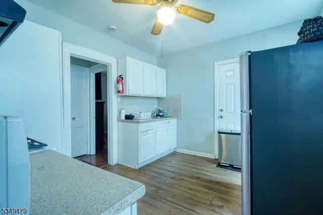 63 Grove St, Bloomfield Twp, NJ 07003 - kitchen with freestanding refrigerator, white cabinetry, wood finished floors, light countertops, and a ceiling fan