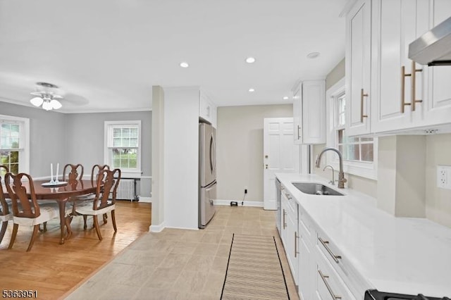 329 Hillside Ave, Livingston Twp, NJ 07039 - kitchen with freestanding refrigerator, exhaust hood, radiator, light countertops, and recessed lighting