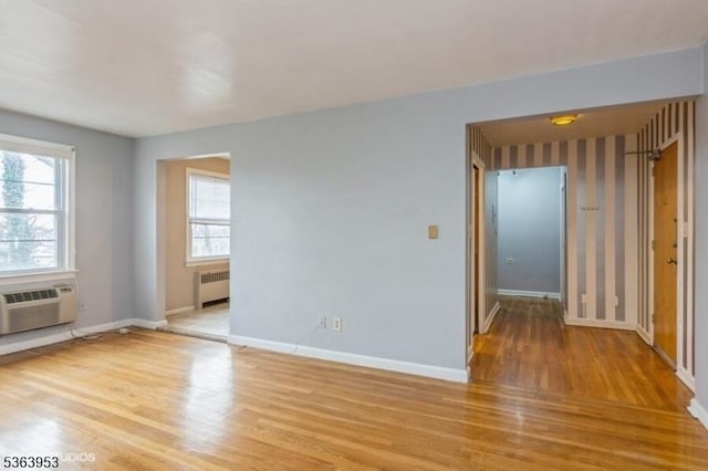 24 Hutton Ave Unit 46, West Orange Twp, NJ 07052 - unfurnished room featuring radiator, light wood-style floors, plenty of natural light, and a wall mounted AC