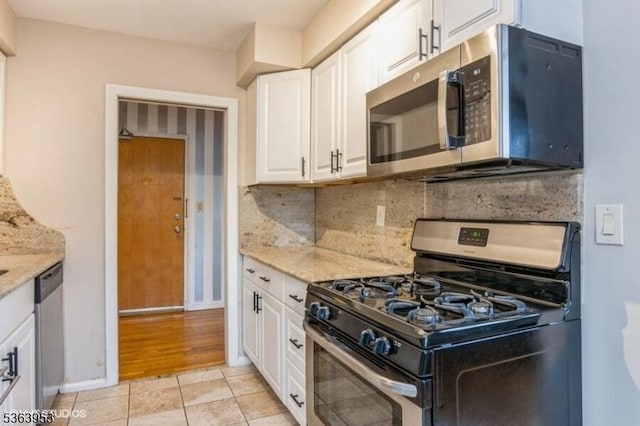 24 Hutton Ave Unit 46, West Orange Twp, NJ 07052 - kitchen with stainless steel appliances, white cabinets, light stone counters, and light tile patterned floors