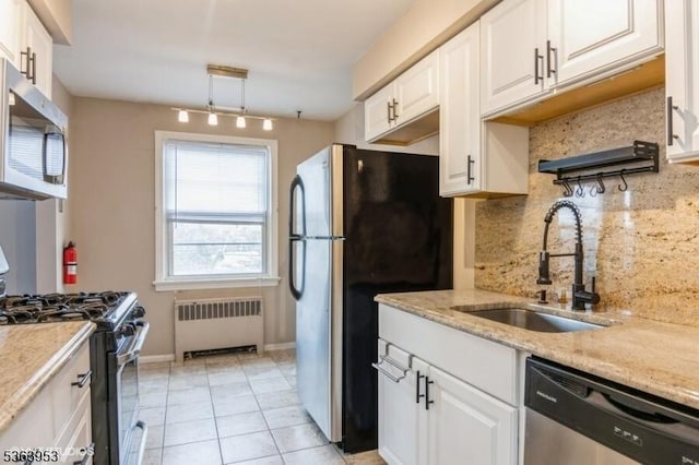 24 Hutton Ave Unit 46, West Orange Twp, NJ 07052 - kitchen with stainless steel appliances, radiator, backsplash, white cabinetry, and light tile patterned floors