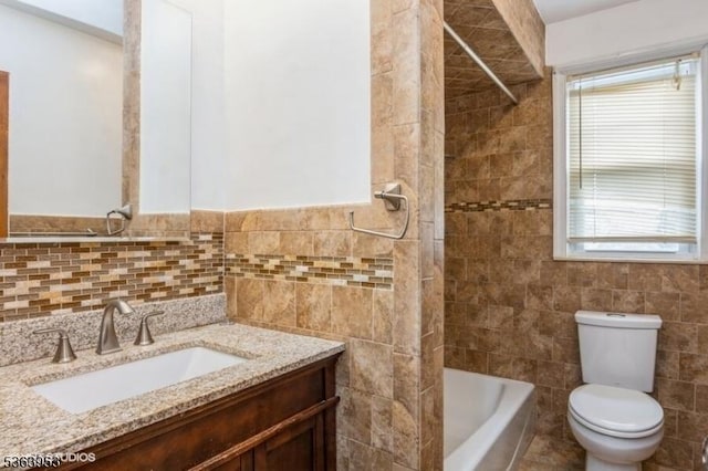 24 Hutton Ave Unit 46, West Orange Twp, NJ 07052 - bathroom featuring tile walls, vanity, healthy amount of natural light, and tub / shower combination