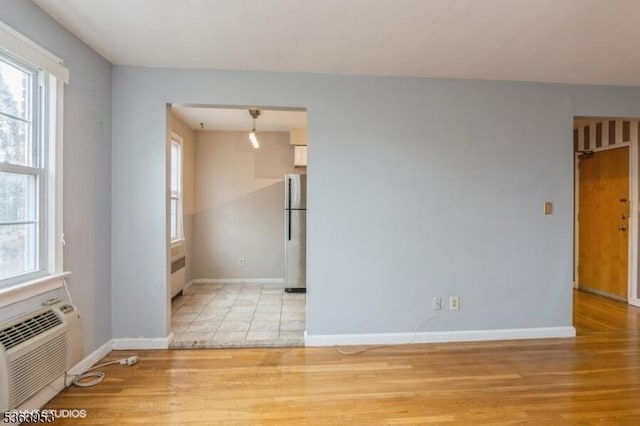 24 Hutton Ave Unit 46, West Orange Twp, NJ 07052 - empty room featuring plenty of natural light, light wood-style floors, and radiator heating unit