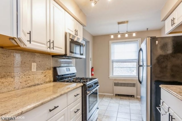 24 Hutton Ave Unit 46, West Orange Twp, NJ 07052 - kitchen with appliances with stainless steel finishes, radiator, backsplash, white cabinetry, and rail lighting