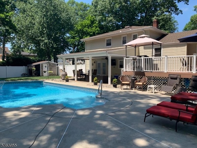 85 Stonehenge Ter, Clark Twp, NJ 07066 - view of swimming pool featuring a patio area, a storage shed, french doors, and a deck