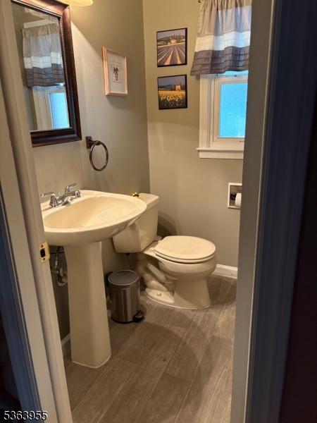 85 Stonehenge Ter, Clark Twp, NJ 07066 - half bathroom with toilet and wood finished floors