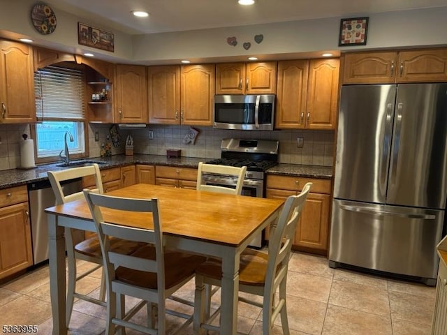 85 Stonehenge Ter, Clark Twp, NJ 07066 - kitchen with appliances with stainless steel finishes, backsplash, brown cabinetry, recessed lighting, and light tile patterned flooring