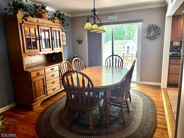 85 Stonehenge Ter, Clark Twp, NJ 07066 - dining space featuring wood finished floors, ornamental molding, and a chandelier