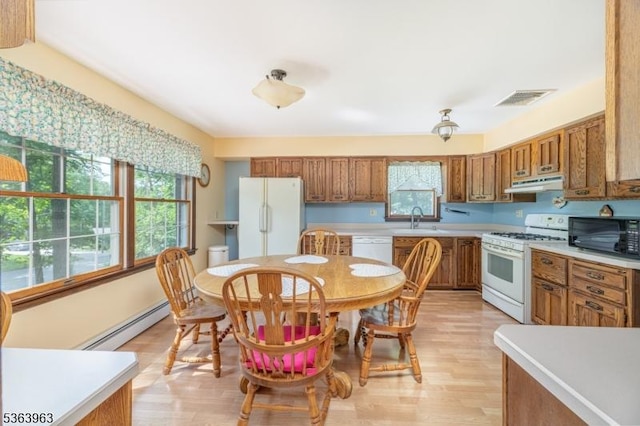46 Deerfield Dr, Hardyston Twp, NJ 07416 - kitchen with white appliances, a baseboard heating unit, under cabinet range hood, brown cabinets, and light countertops