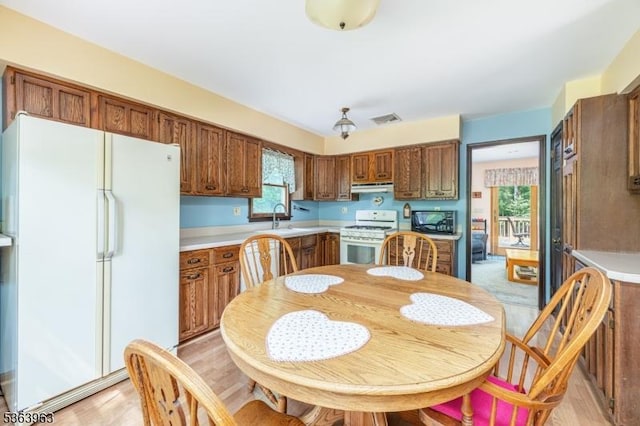 46 Deerfield Dr, Hardyston Twp, NJ 07416 - kitchen featuring white appliances, ventilation hood, light countertops, and brown cabinets