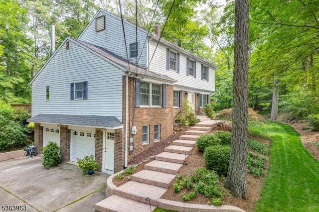 46 Deerfield Dr, Hardyston Twp, NJ 07416 - view of front of house featuring stairway, driveway, an attached garage, and brick siding