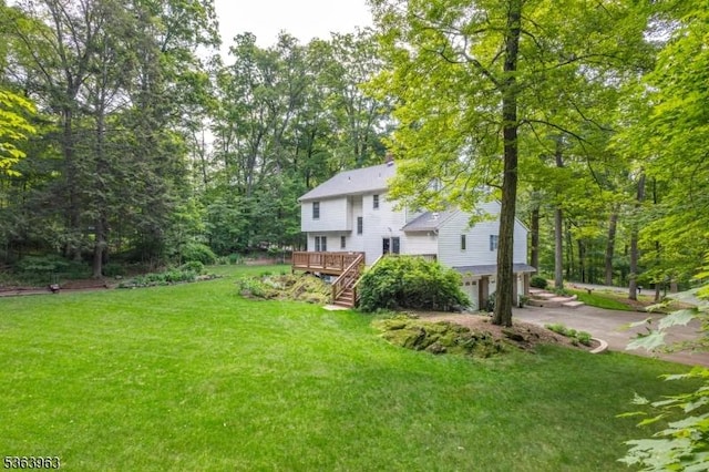 46 Deerfield Dr, Hardyston Twp, NJ 07416 - view of green lawn featuring concrete driveway, stairway, a deck, and a garage