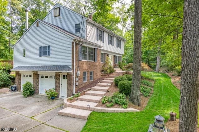 46 Deerfield Dr, Hardyston Twp, NJ 07416 - view of front facade with brick siding, stairway, driveway, an attached garage, and a chimney