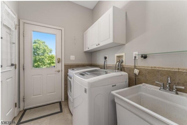 1611 Adams Dr, Greenwich Twp, NJ 08886 - washroom with tile walls, cabinet space, separate washer and dryer, light tile patterned floors, and a wainscoted wall