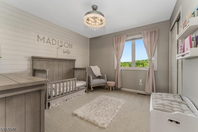1611 Adams Dr, Greenwich Twp, NJ 08886 - carpeted bedroom with a chandelier, a crib, and wooden walls