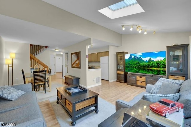 143 Canal Way, Hackettstown Town, NJ 07840 - living room featuring light wood-style floors, stairway, and a skylight