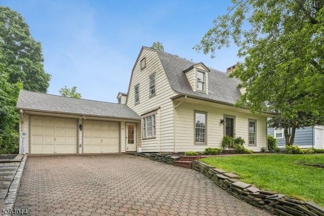 64 Mckinley Ave, West Caldwell Twp, NJ 07006 - view of front facade featuring a garage, decorative driveway, a front lawn, and a shingled roof