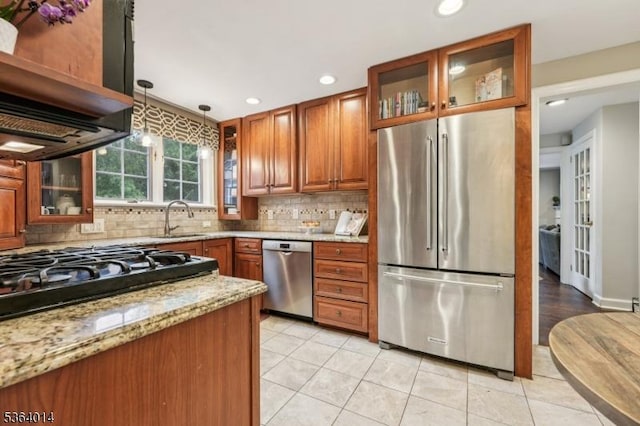 64 Mckinley Ave, West Caldwell Twp, NJ 07006 - kitchen featuring stainless steel appliances, backsplash, brown cabinetry, light stone counters, and recessed lighting