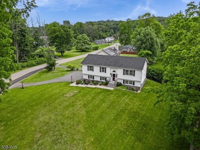 31 Arthur Ave, Andover Twp, NJ 07860 - view of front of home with a front yard, a view of trees, and asphalt driveway