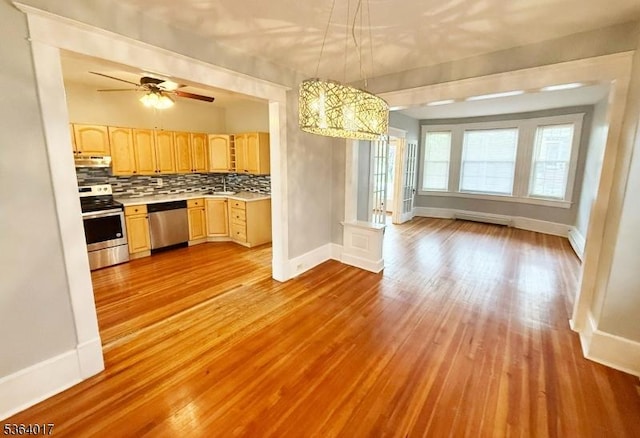 191 Summit Ave, Phillipsburg Town, NJ 08865 - kitchen featuring appliances with stainless steel finishes, light countertops, light brown cabinetry, light wood finished floors, and decorative backsplash