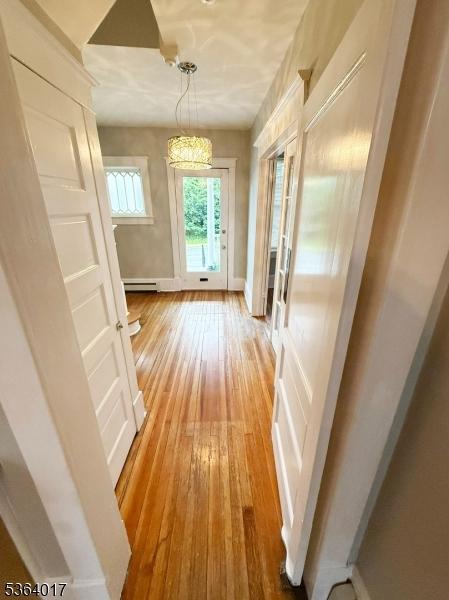 191 Summit Ave, Phillipsburg Town, NJ 08865 - corridor with light wood-type flooring and a chandelier