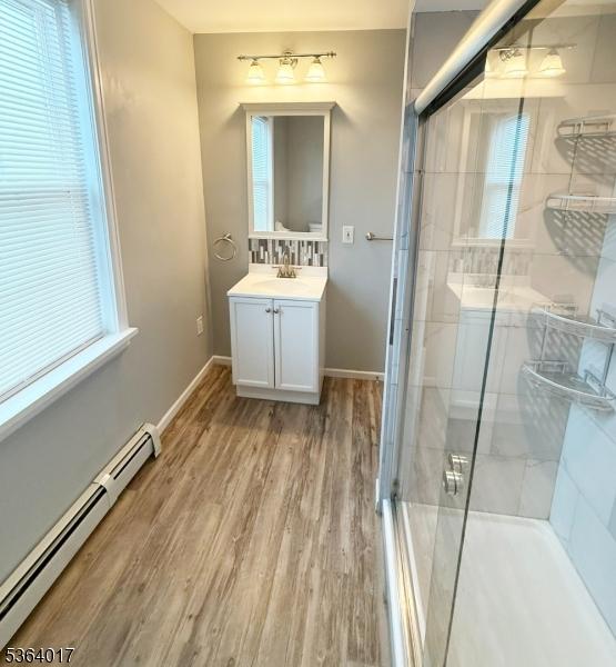191 Summit Ave, Phillipsburg Town, NJ 08865 - bathroom with baseboard heating, vanity, a shower stall, and wood finished floors