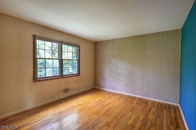 192 Carol Jean Way, Branchburg Twp, NJ 08876 - empty room with wood finished floors and an accent wall