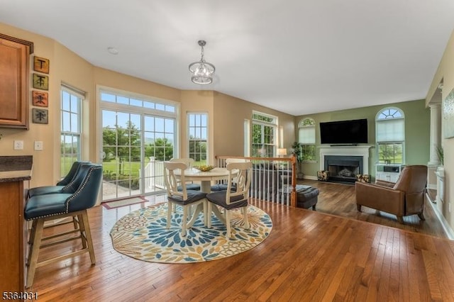 13 Highlands Way, Lopatcong Twp, NJ 08865 - dining area featuring hardwood / wood-style floors, a fireplace, and a chandelier