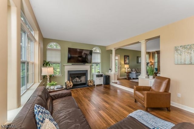 13 Highlands Way, Lopatcong Twp, NJ 08865 - living room featuring ornate columns, plenty of natural light, wood finished floors, and a fireplace with raised hearth