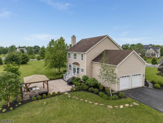13 Highlands Way, Lopatcong Twp, NJ 08865 - back of house featuring a gazebo, asphalt driveway, a chimney, and a lawn