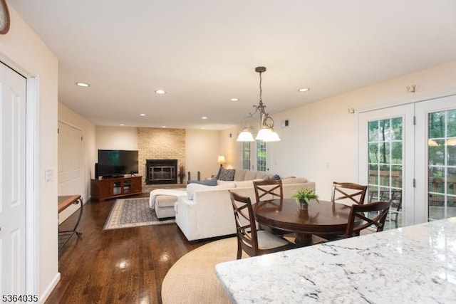 13 Deer Path Cir, Green Brook Twp, NJ 08812 - dining area with dark wood-style floors, healthy amount of natural light, recessed lighting, and a brick fireplace