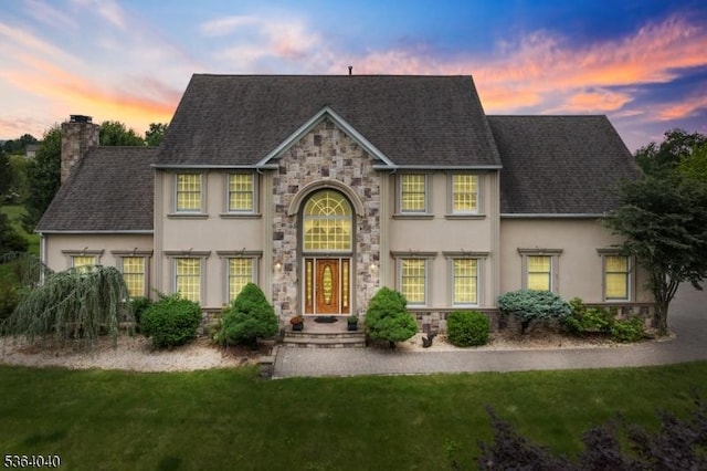 31 Deer Path, Hillsborough Twp, NJ 08844 - view of front of home with stucco siding, stone siding, a chimney, a front lawn, and a shingled roof