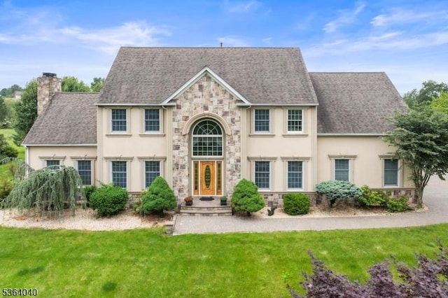 31 Deer Path, Hillsborough Twp, NJ 08844 - view of front of home featuring stone siding, stucco siding, a front lawn, and a chimney