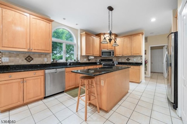 31 Deer Path, Hillsborough Twp, NJ 08844 - kitchen with stainless steel appliances, a center island, tasteful backsplash, light tile patterned flooring, and hanging light fixtures