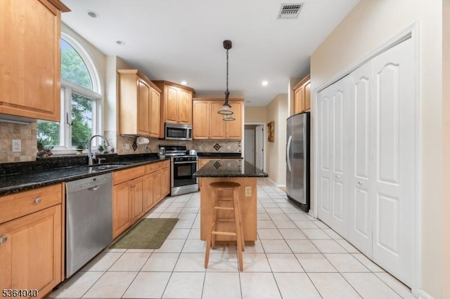 31 Deer Path, Hillsborough Twp, NJ 08844 - kitchen with appliances with stainless steel finishes, a kitchen island, decorative backsplash, dark stone countertops, and light tile patterned flooring