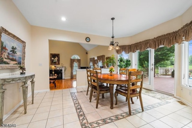 31 Deer Path, Hillsborough Twp, NJ 08844 - dining space featuring plenty of natural light, light tile patterned flooring, a warm lit fireplace, a chandelier, and lofted ceiling