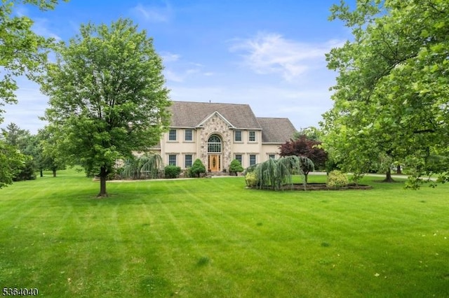 31 Deer Path, Hillsborough Twp, NJ 08844 - colonial-style house featuring stone siding, a front yard, and stucco siding