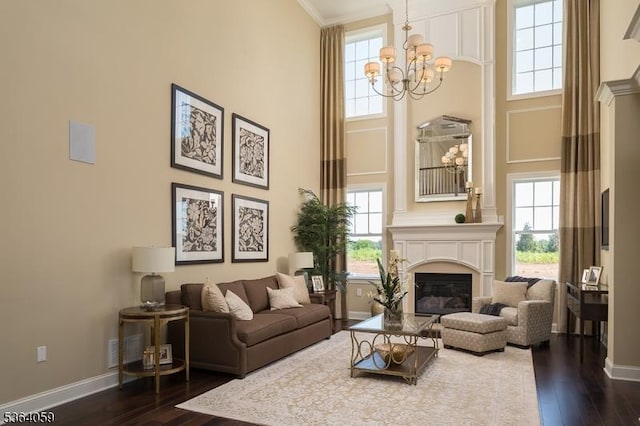 4 Leidl Cir, Hillsborough Twp, NJ 08844 - living room with a high ceiling, a chandelier, dark wood-style floors, plenty of natural light, and ornamental molding